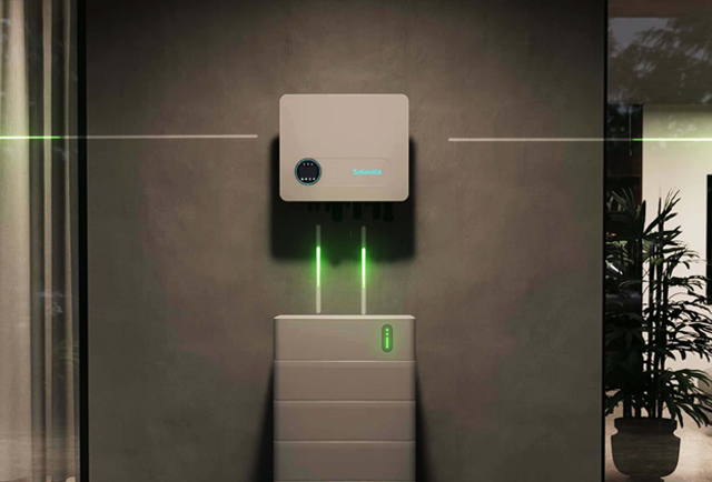 Solavita home inverter connected to modular battery unit with glowing green energy flow on indoor wall